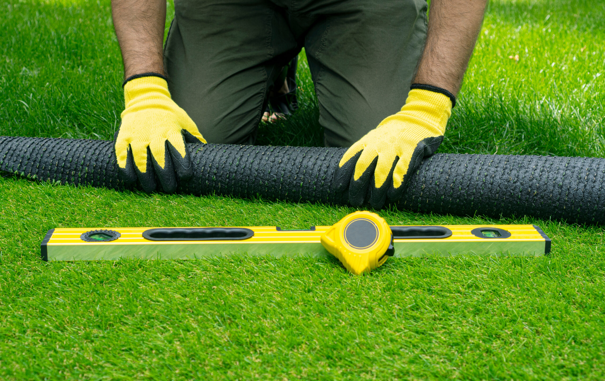 man installing artificial turf man installing artificial turf