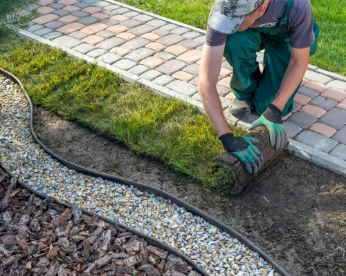 landscape gardener laying turf